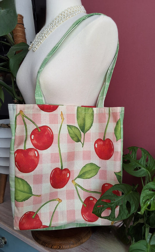 Tote bag covered in cherry design, front view